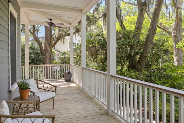 deck with a ceiling fan and a porch