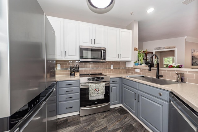 1121 Basildon Rd, Mount Pleasant, SC 29466 - kitchen with appliances with stainless steel finishes, gray cabinetry, backsplash, white cabinetry, and light countertops