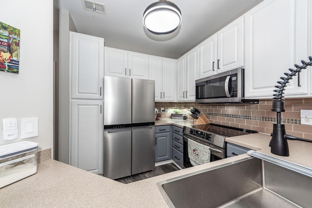 1121 Basildon Rd, Mount Pleasant, SC 29466 - kitchen with stainless steel appliances, decorative backsplash, and white cabinetry