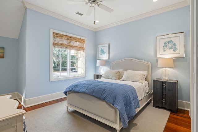 bedroom with dark wood-type flooring, ceiling fan, and ornamental molding