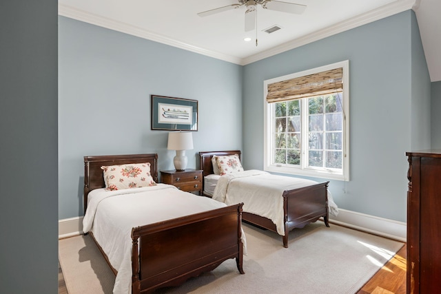 bedroom with ornamental molding and ceiling fan