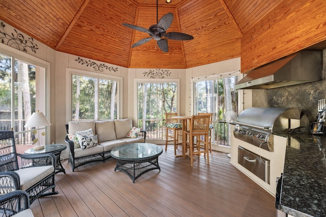 interior space with ceiling fan, vaulted ceiling, wooden ceiling, and a healthy amount of sunlight