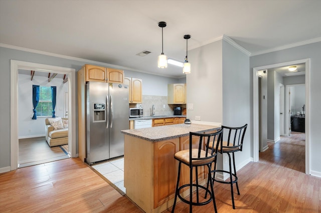 14 Aldene Ave, Goose Creek, SC 29445 - kitchen featuring appliances with stainless steel finishes, a sink, light brown cabinets, a peninsula, and a breakfast bar area