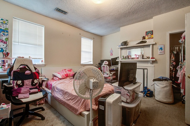 bedroom featuring a textured ceiling and carpet floors