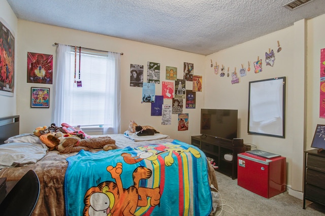 carpeted bedroom featuring a textured ceiling