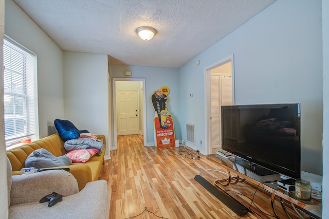 living room featuring hardwood / wood-style flooring and a textured ceiling