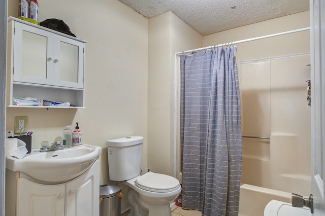 full bathroom featuring a textured ceiling, shower / tub combo with curtain, vanity, tile patterned floors, and toilet