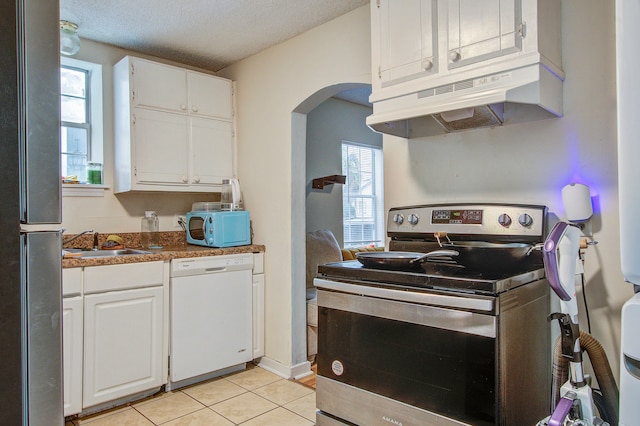 kitchen featuring white cabinets, a textured ceiling, and appliances with stainless steel finishes