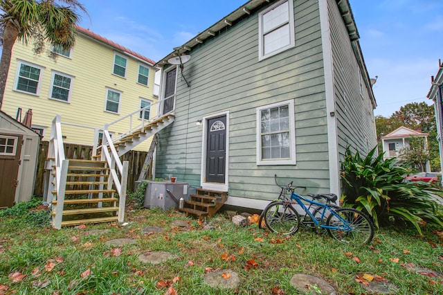 rear view of property with a shed