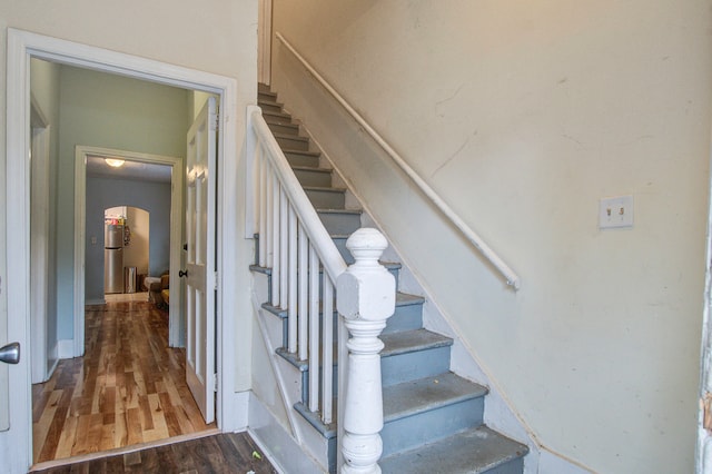 stairway with hardwood / wood-style flooring