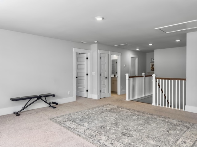 interior space featuring carpet flooring, baseboards, recessed lighting, and attic access
