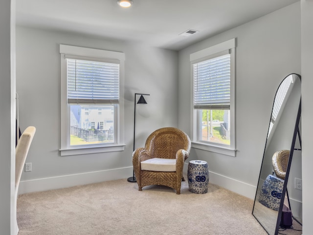 sitting room featuring visible vents, baseboards, and carpet