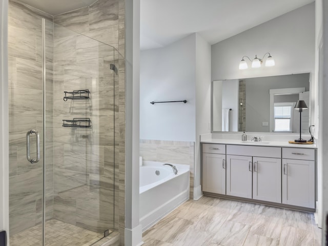 full bathroom with vanity, a bath, and a stall shower