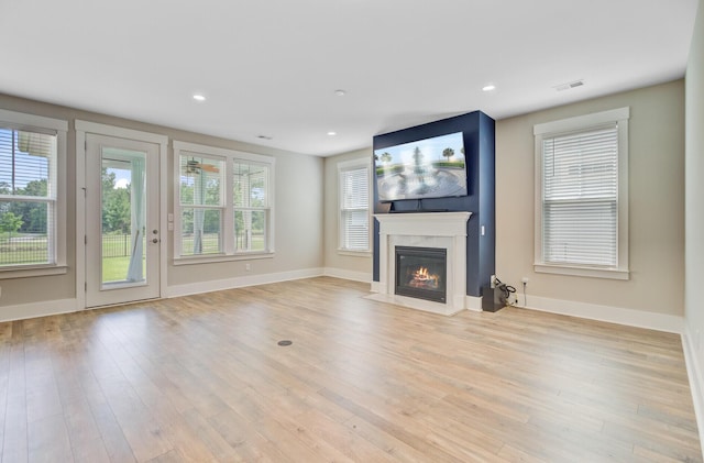 357 Parish Farms Dr, Summerville, SC 29486 - unfurnished living room featuring a fireplace with flush hearth, light wood-type flooring, healthy amount of natural light, and recessed lighting