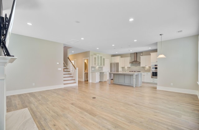 357 Parish Farms Dr, Summerville, SC 29486 - unfurnished living room featuring light wood-style flooring, stairs, and recessed lighting