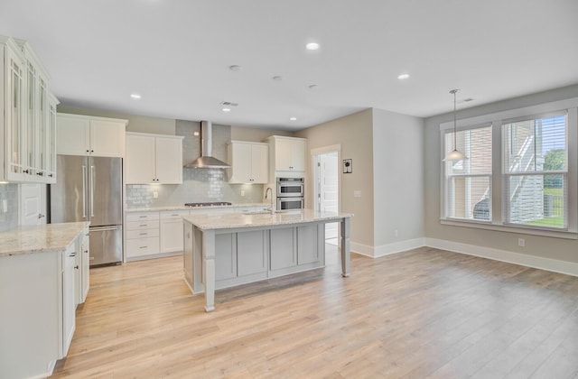 357 Parish Farms Dr, Summerville, SC 29486 - kitchen featuring wall chimney range hood, appliances with stainless steel finishes, backsplash, light wood finished floors, and recessed lighting