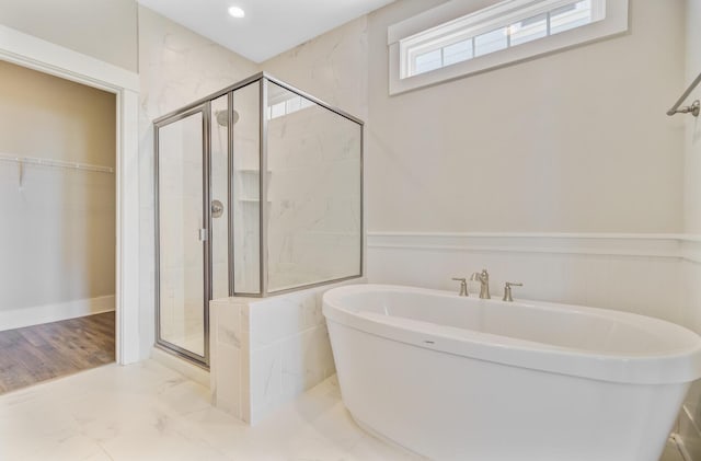357 Parish Farms Dr, Summerville, SC 29486 - full bath featuring a freestanding tub, a shower stall, marble look tile flooring, a walk in closet, and wainscoting