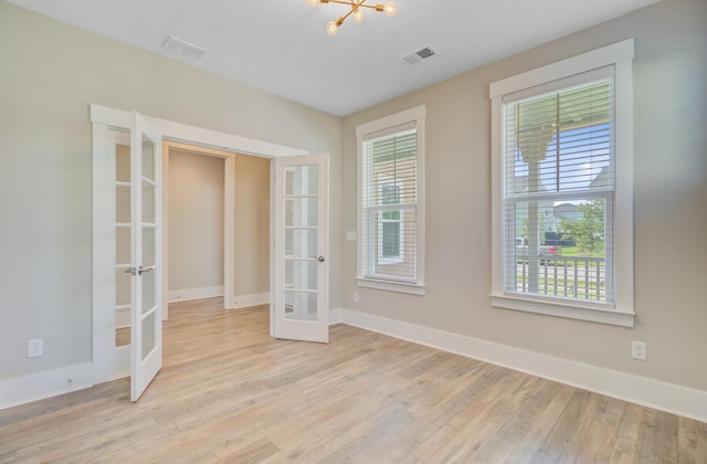 357 Parish Farms Dr, Summerville, SC 29486 - spare room with french doors, light wood finished floors, and a chandelier