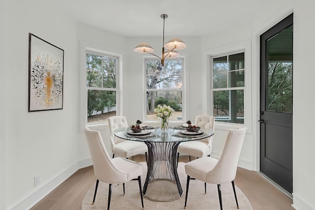 dining room with an inviting chandelier and light wood-type flooring