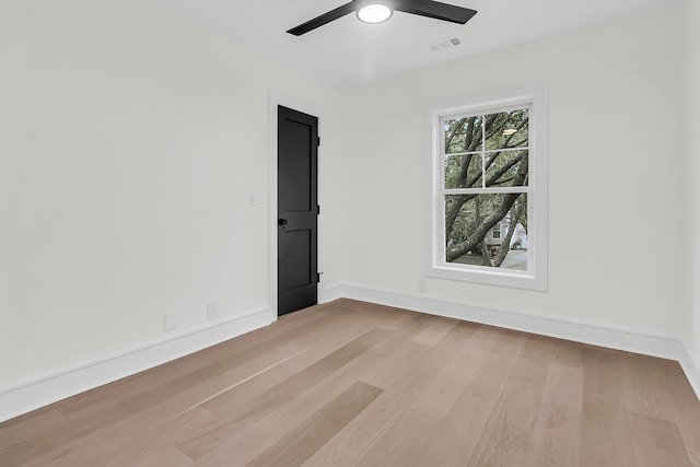 spare room with ceiling fan and light wood-type flooring