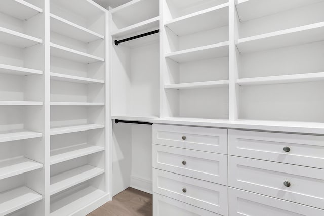 spacious closet with light hardwood / wood-style flooring