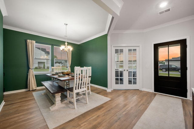 701 Squire Pope Rd, Summerville, SC 29486 - dining room featuring french doors, wood finished floors, a chandelier, and crown molding
