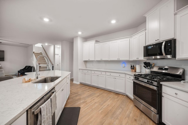 701 Squire Pope Rd, Summerville, SC 29486 - kitchen featuring appliances with stainless steel finishes, light wood-style floors, white cabinetry, open floor plan, and recessed lighting