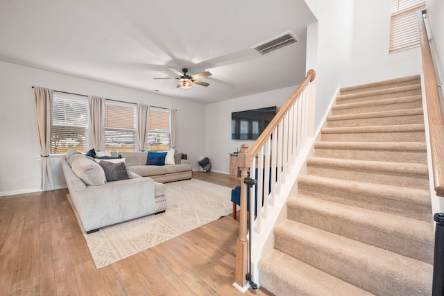 701 Squire Pope Rd, Summerville, SC 29486 - living area with stairs, a ceiling fan, and hardwood / wood-style floors