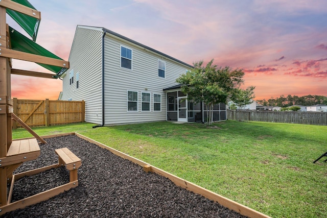 701 Squire Pope Rd, Summerville, SC 29486 - back of property at dusk with a sunroom and a fenced backyard