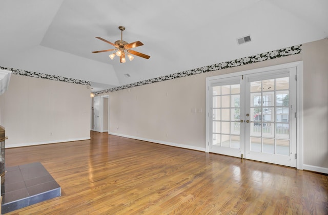 interior space with ceiling fan, french doors, wood-type flooring, and vaulted ceiling