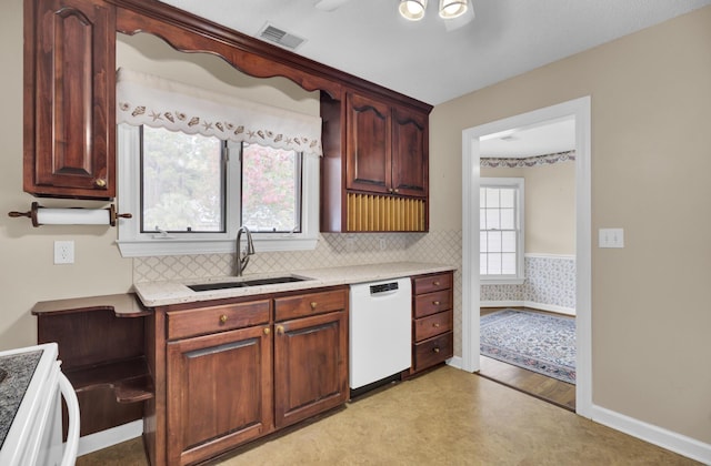 kitchen featuring white appliances, light hardwood / wood-style floors, tasteful backsplash, and sink