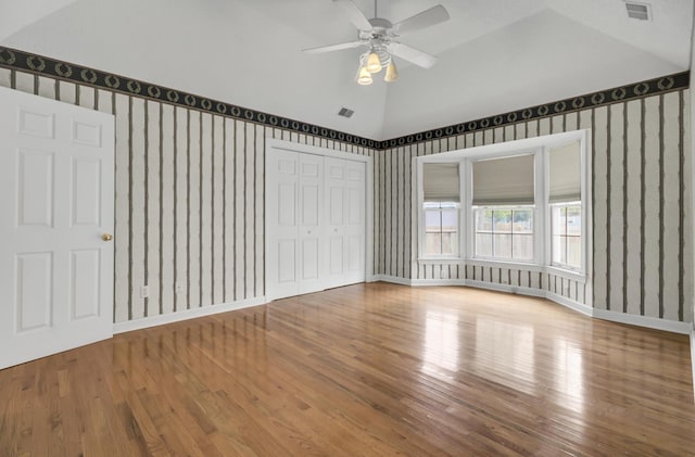 interior space featuring hardwood / wood-style floors, ceiling fan, and lofted ceiling