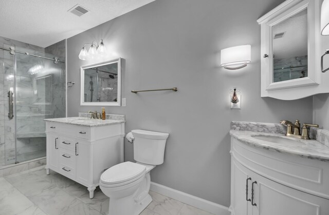 bathroom featuring a shower with door, vanity, and toilet