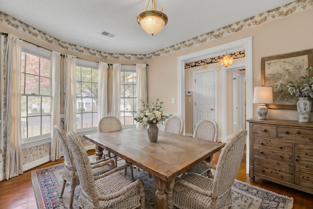 dining area with hardwood / wood-style flooring and plenty of natural light