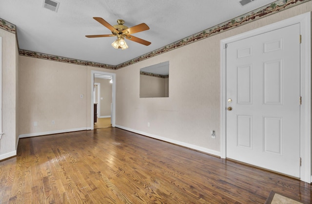 spare room featuring hardwood / wood-style floors, ceiling fan, and a textured ceiling