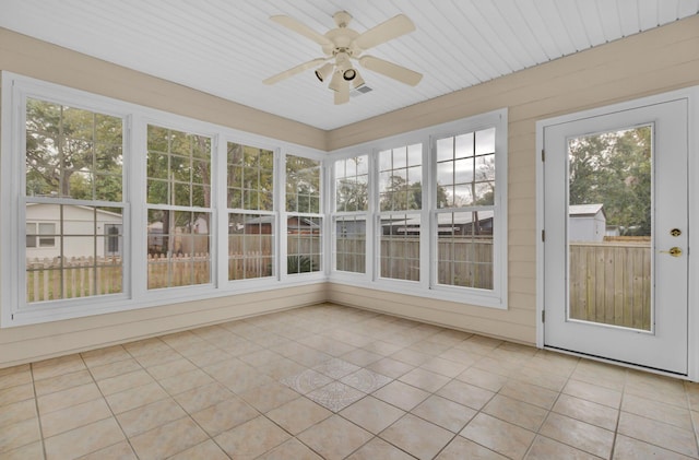 unfurnished sunroom with ceiling fan