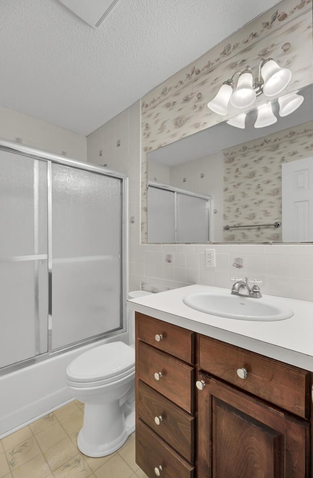 full bathroom featuring tasteful backsplash, enclosed tub / shower combo, a textured ceiling, toilet, and vanity