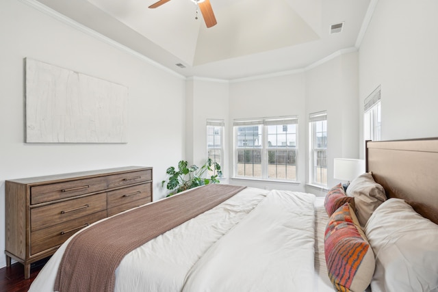 bedroom featuring ceiling fan, ornamental molding, dark hardwood / wood-style floors, and a raised ceiling