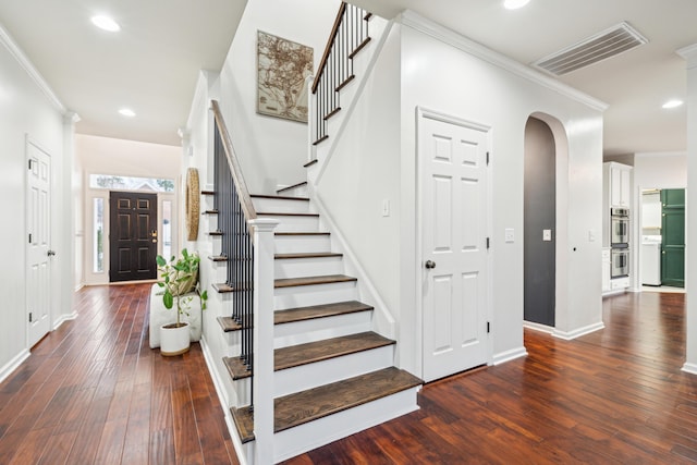 stairs featuring crown molding and hardwood / wood-style floors