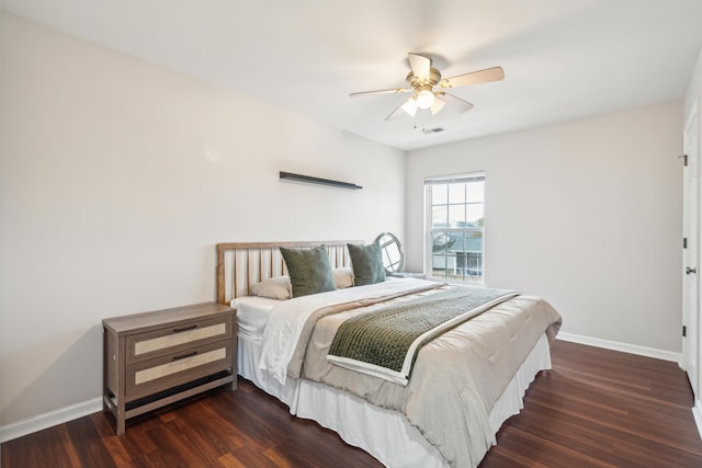 bedroom with dark hardwood / wood-style floors and ceiling fan