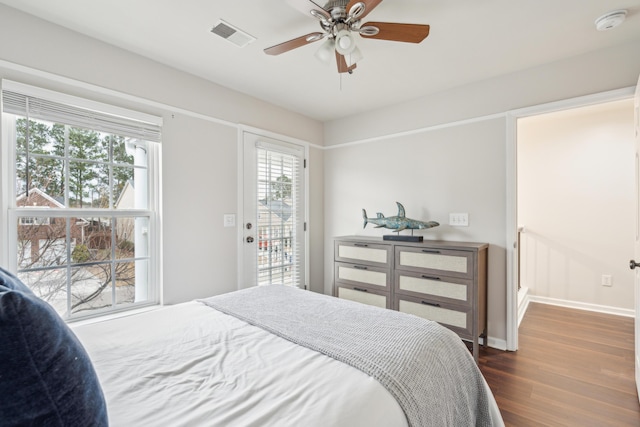 bedroom with dark wood-type flooring, ceiling fan, access to exterior, and multiple windows