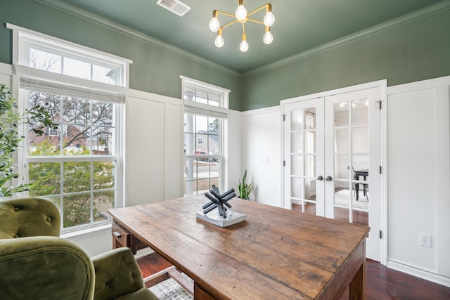 dining space with french doors, ornamental molding, dark wood-type flooring, and a notable chandelier