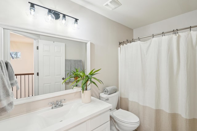 bathroom with vanity, toilet, and a shower with shower curtain