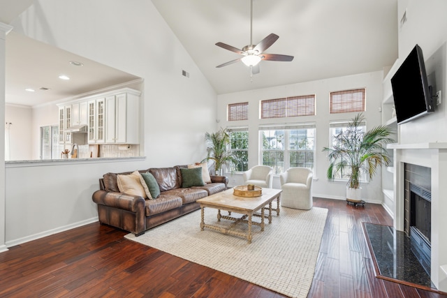 living room featuring dark hardwood / wood-style flooring, sink, high vaulted ceiling, and ceiling fan