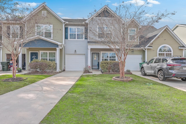 view of property with a garage and a front yard