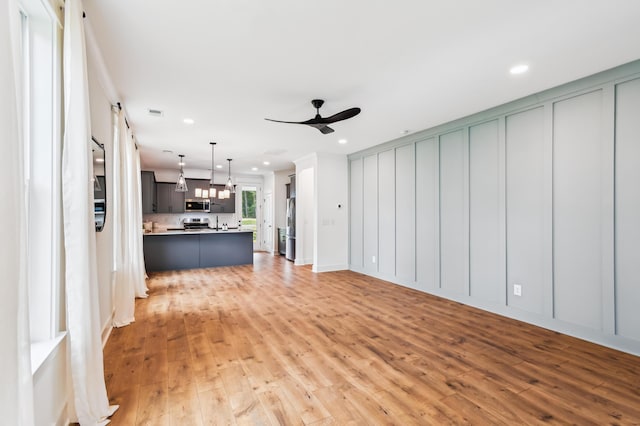 3806 Grateful Rd, North Charleston, SC 29420 - unfurnished living room with ceiling fan, light wood-style floors, recessed lighting, and a chandelier