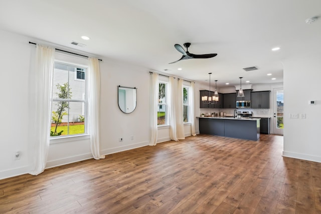 3806 Grateful Rd, North Charleston, SC 29420 - unfurnished living room with a ceiling fan, recessed lighting, baseboards, wood finished floors, and a sink