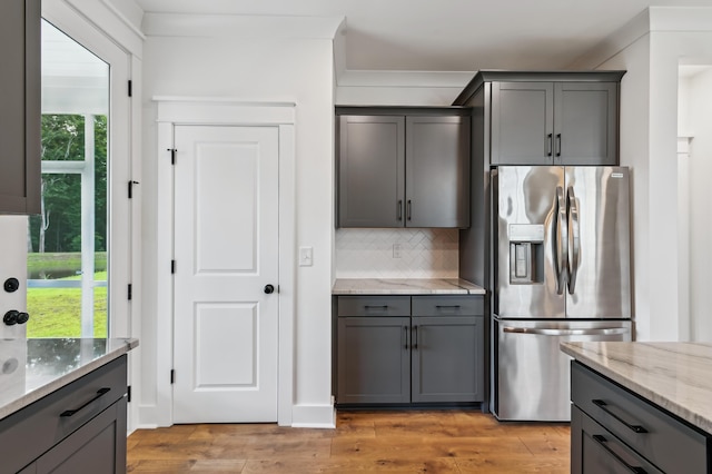 3806 Grateful Rd, North Charleston, SC 29420 - kitchen with stainless steel refrigerator with ice dispenser, gray cabinets, tasteful backsplash, and light stone counters