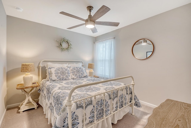 carpeted bedroom featuring a ceiling fan and baseboards