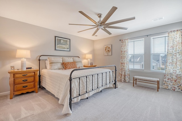 bedroom with visible vents, baseboards, ceiling fan, and carpet flooring